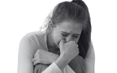 Photo of a white woman crouching in pain