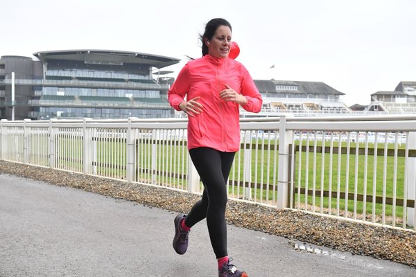 Anna running in a Wellbeing of Women Vest
