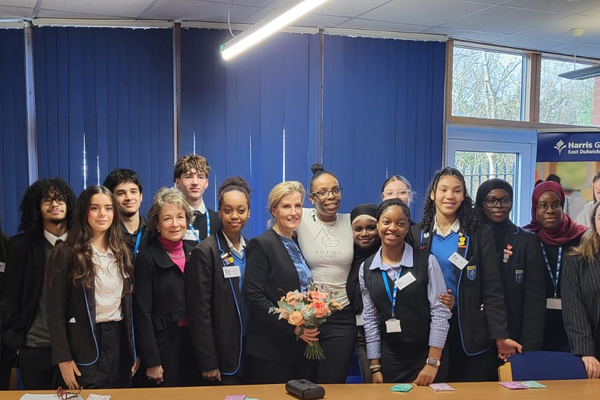 HRH The Duchess of Edinburgh, standing with a group of secondary school children; boys and girls. With Professor Dame Lesley Regan and Tanya Simon Hall