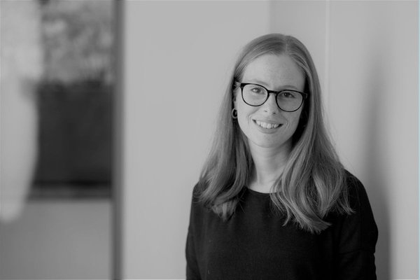 A black and white image of Wellbeing of Women researcher Rebecca Blaylock smiling