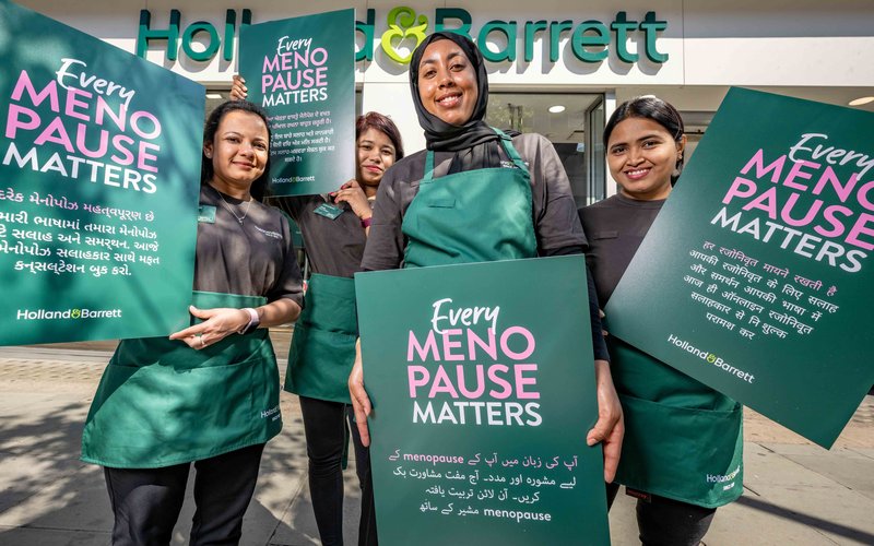 Image shows three women hugging and laughing.