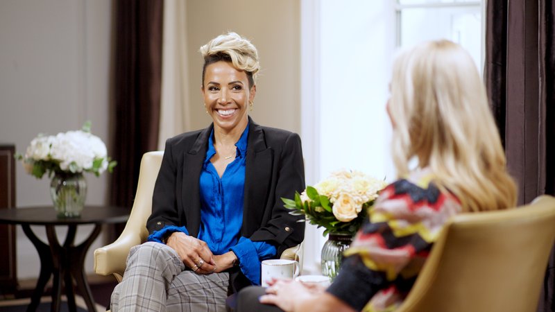 Dame Kelly Holmes smiles at the camera