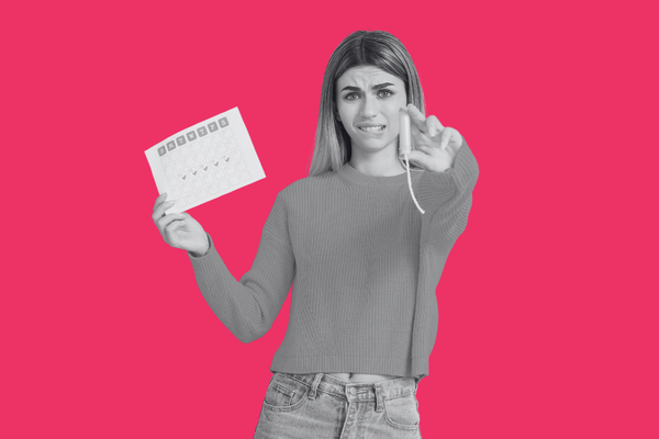A teenager holding a menstrual calendar and tampon looking ocnfused.