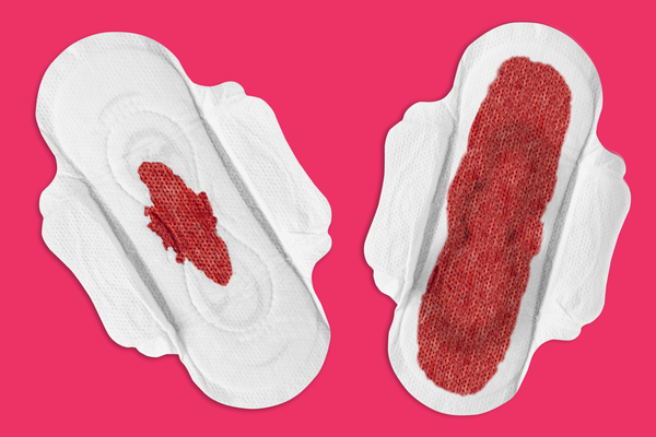 Two sanitary towels. One with a small amount of blood and the second sanitary towel is covered in blood.