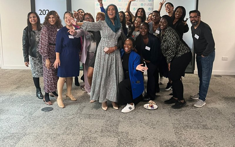 A group of women standing together. There is also one man standing on the right. Dr Nighat Arif stands in the middle of the group.