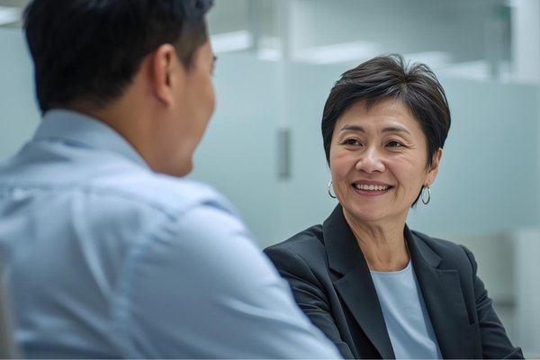 Woman and man talking together at work