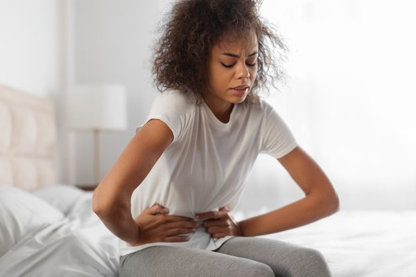 Woman in pain clutching stomach