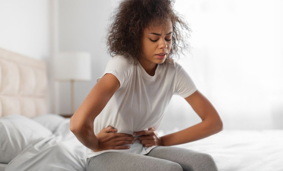 Woman in pain clutching stomach