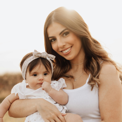 smiling woman holding a baby